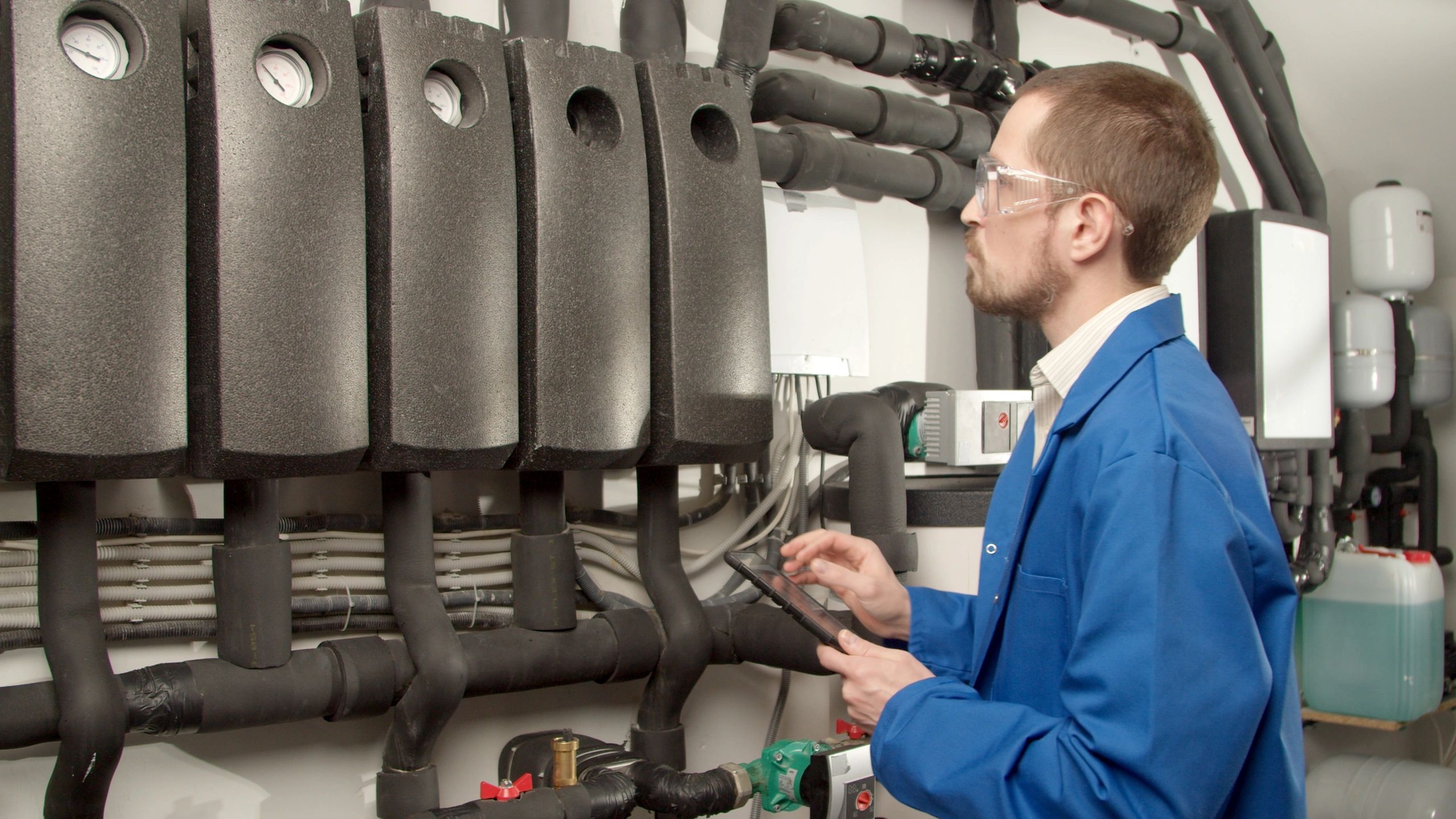 Technician checking gauges during a tankless water heater installation