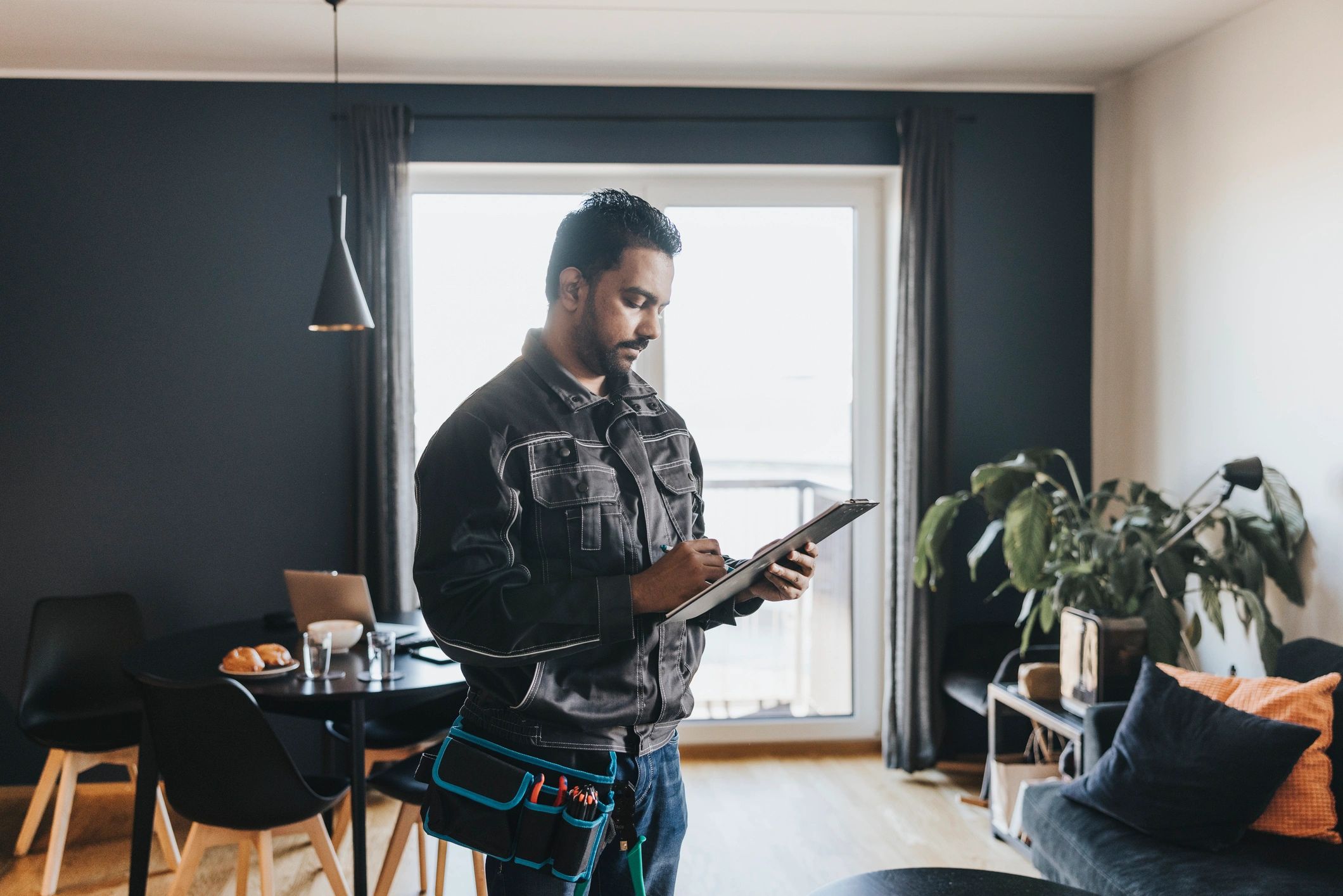 Technician reviewing service details at a customer home