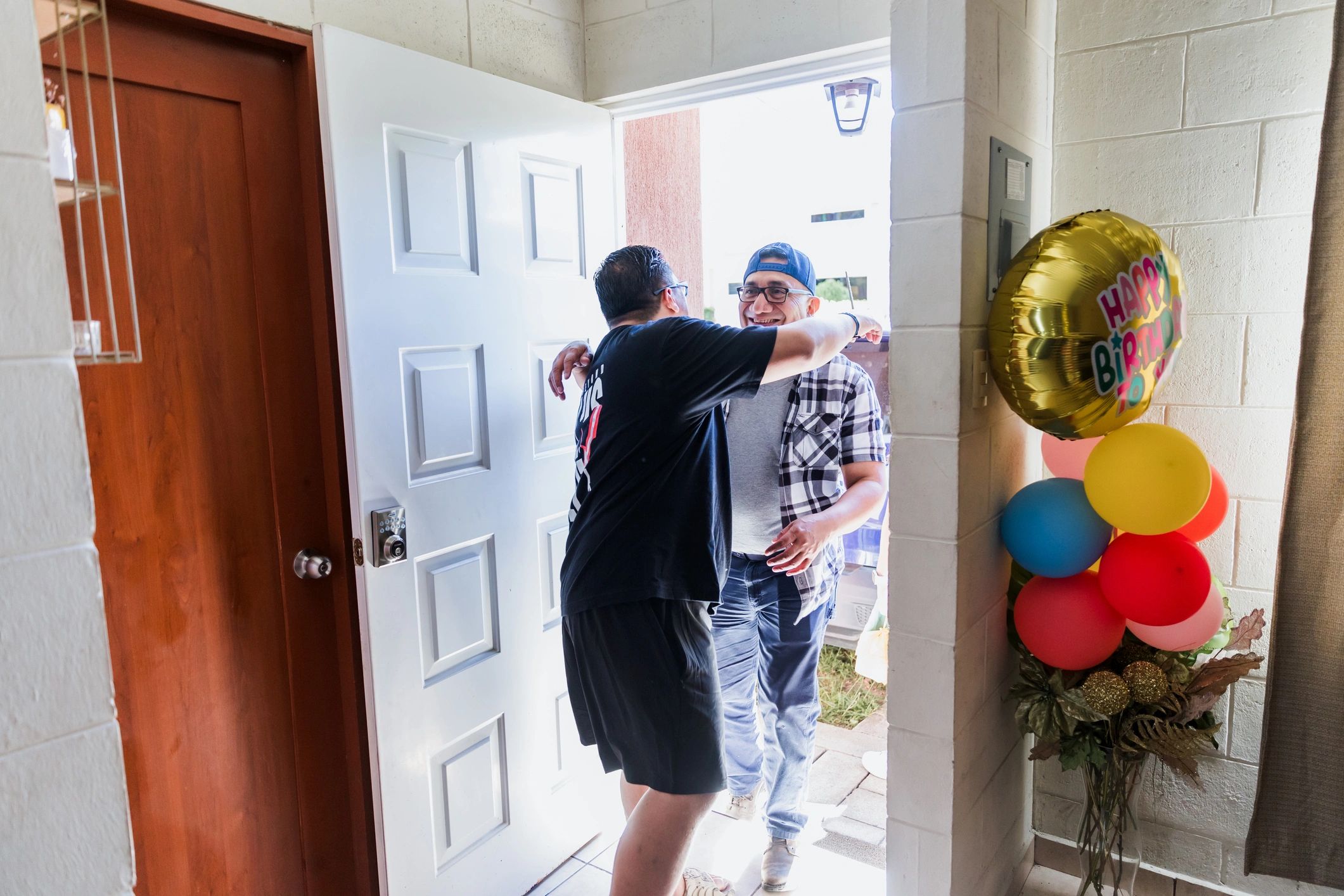 Homeowner greeting a home service technician at the front door