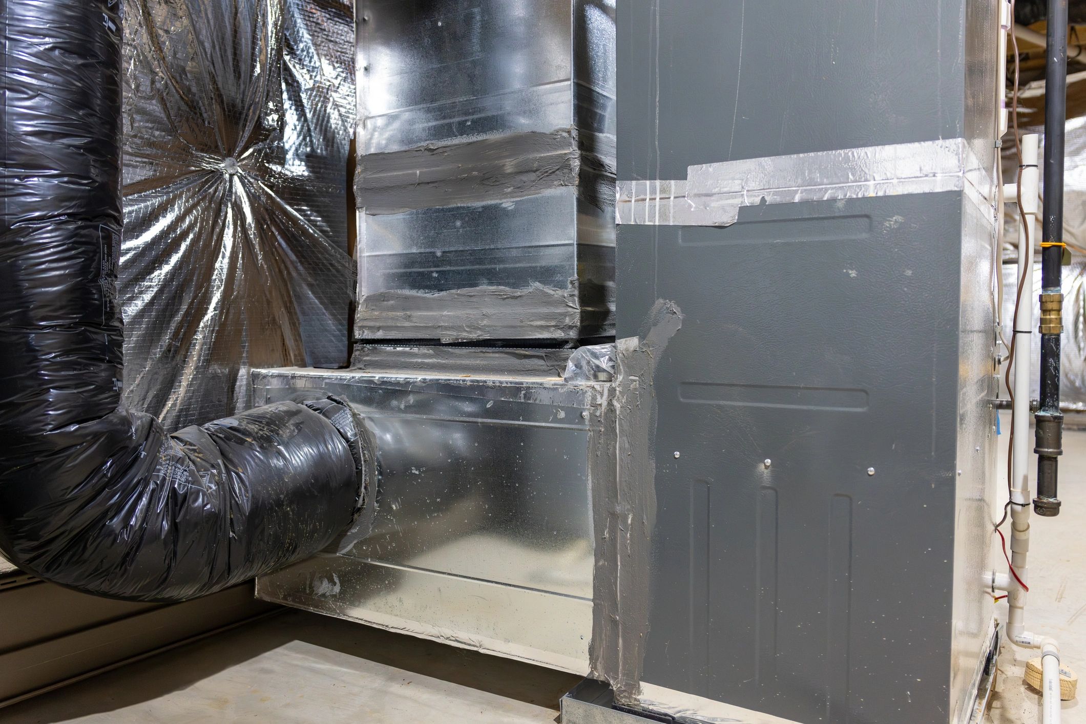 Residential HVAC air handler and ductwork in a basement